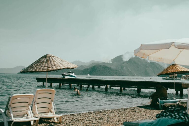 a beach with umbrellas and chairs