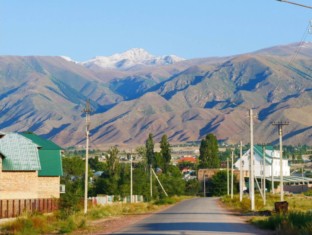 Beautiful shot of mountains near a rural field in Cholpon Ata, Kyrgyzstan