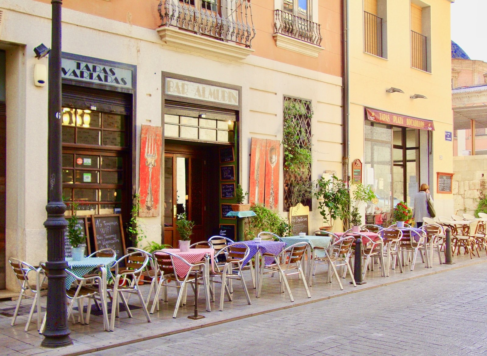 a row of tables and chairs outside a building