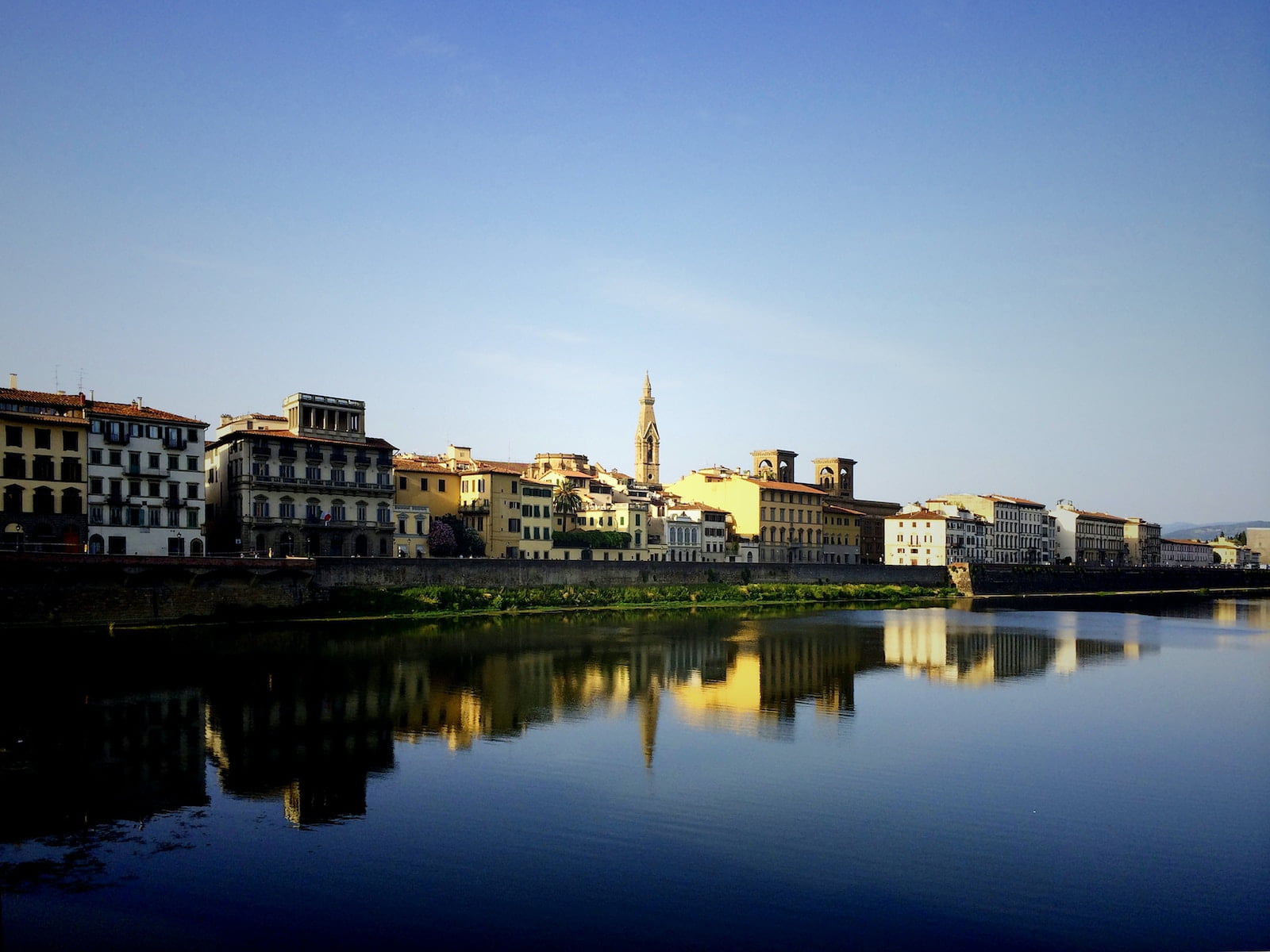 beige buildings near large body of water